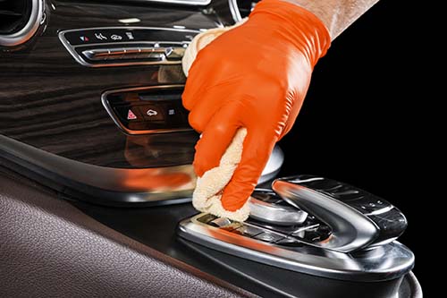 A man cleaning car with microfiber cloth. Car detailing. Valeting concept. Selective focus. Car detailing. Cleaning with sponge. Worker cleaning. Microfiber and cleaning solution to clean