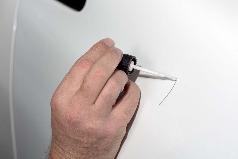 Touch up paint applied to a scratch