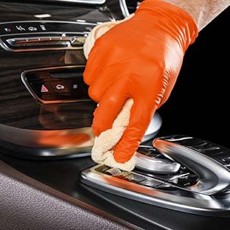 A man cleaning car with microfiber cloth. Car detailing. Valeting concept. Selective focus. Car detailing. Cleaning with sponge. Worker cleaning. Microfiber and cleaning solution to clean
